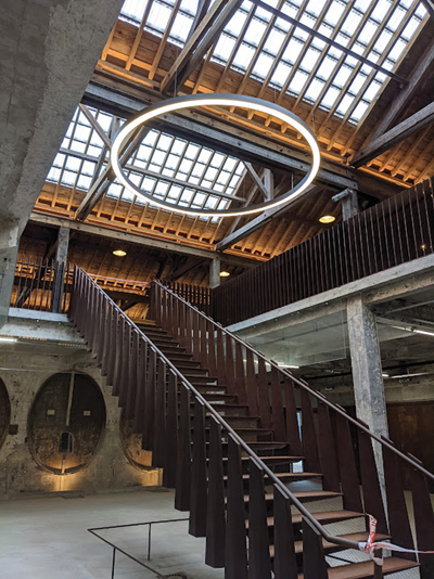 D’une capacité de 300 personnes, la halle sur deux niveaux accueille des marchés, des salons, des expositions. Un escalier central en acier corten relie les deux étages. (© Fondation du patrimoine)